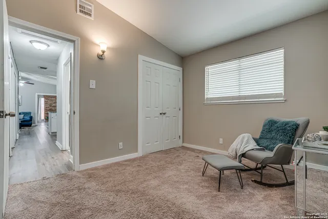 en empty room with furniture and a window