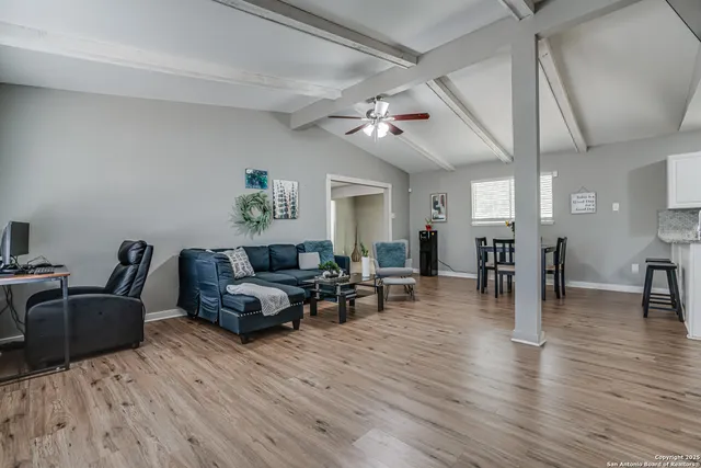 a living room with furniture and wooden floor