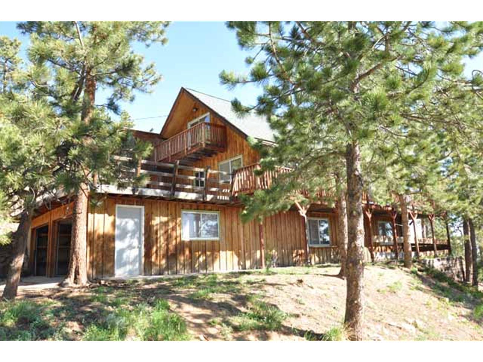 11699 Ridge Road Golden, CO 80403 - Photo 1 of 1 a front view of a house with a yard