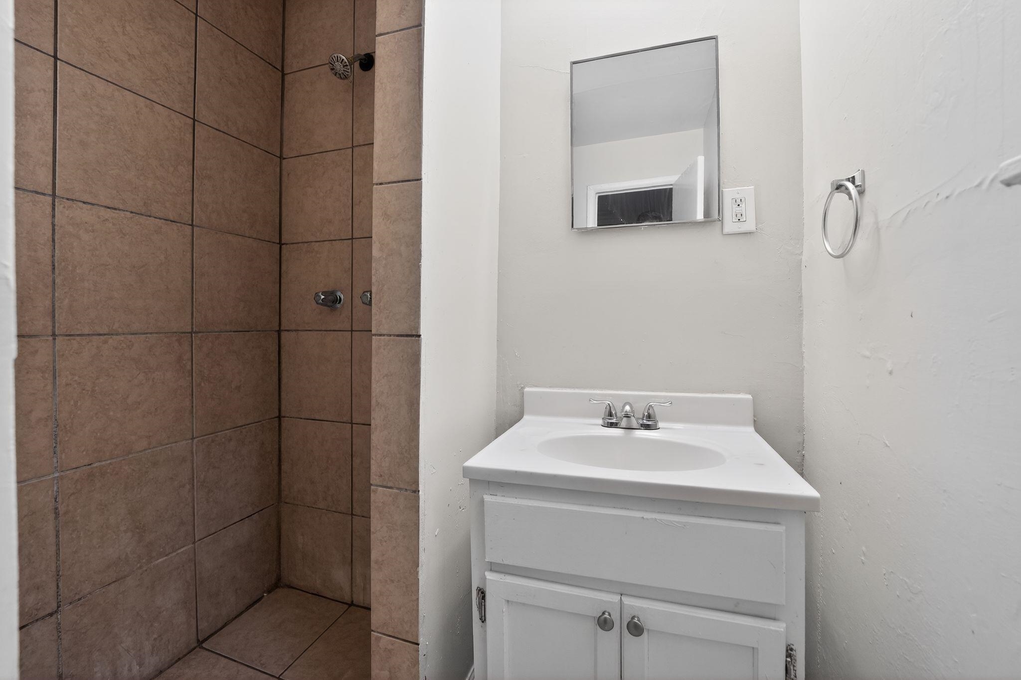 4553 Neely Road Memphis, TN 38109 - Photo 15 of 33 a bathroom with a sink a mirror and vanity
