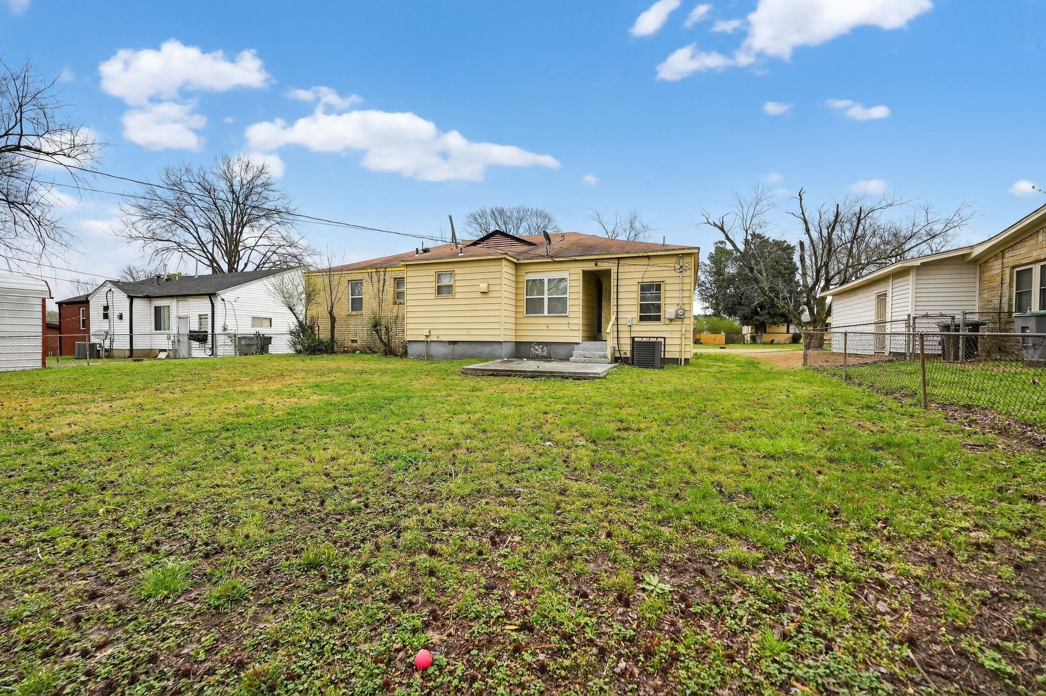 4553 Neely Road Memphis, TN 38109 - Photo 24 of 33 a view of a house with a big yard and large trees
