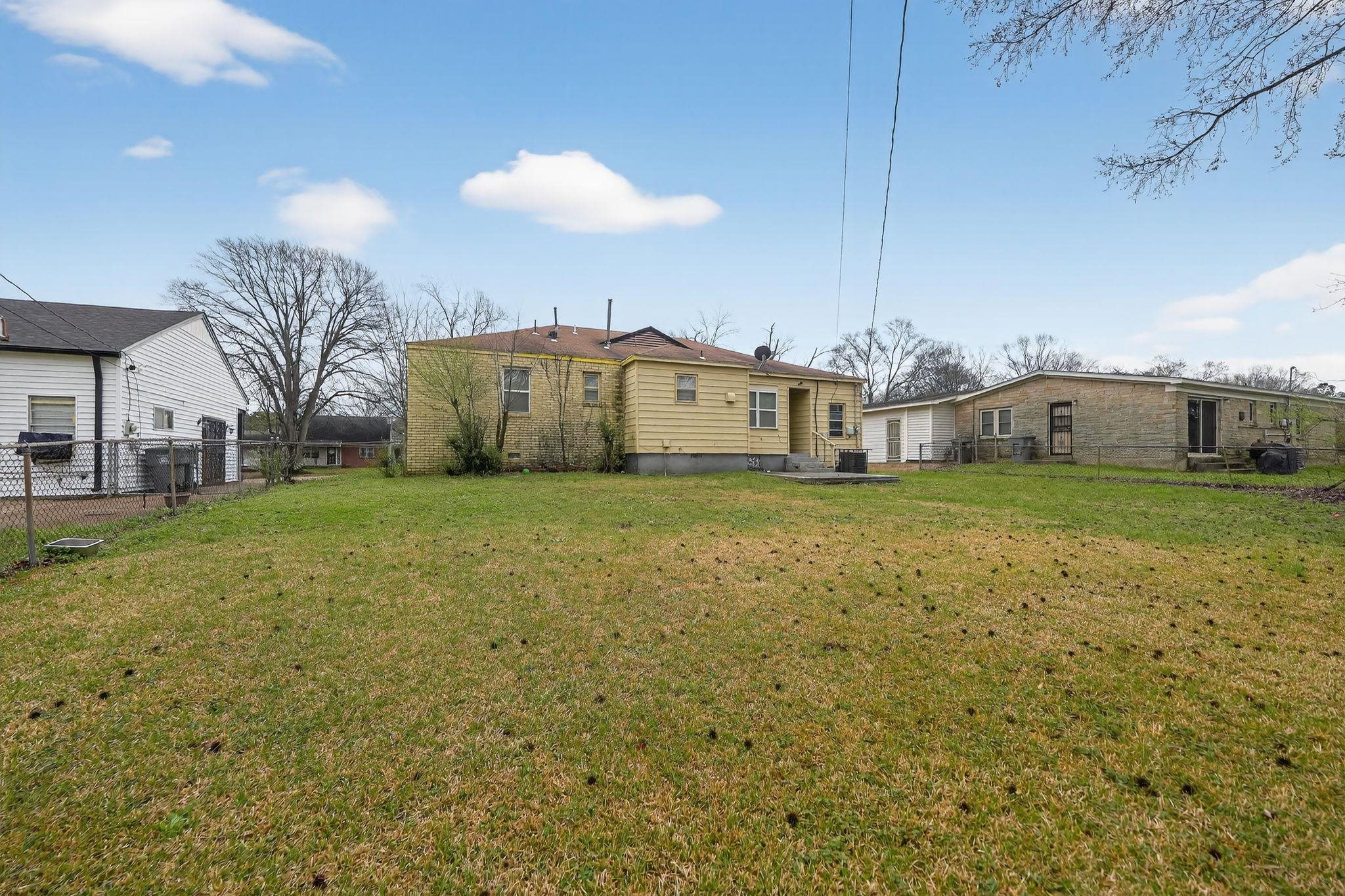 4553 Neely Road Memphis, TN 38109 - Photo 25 of 33 a view of a house with a yard and garage