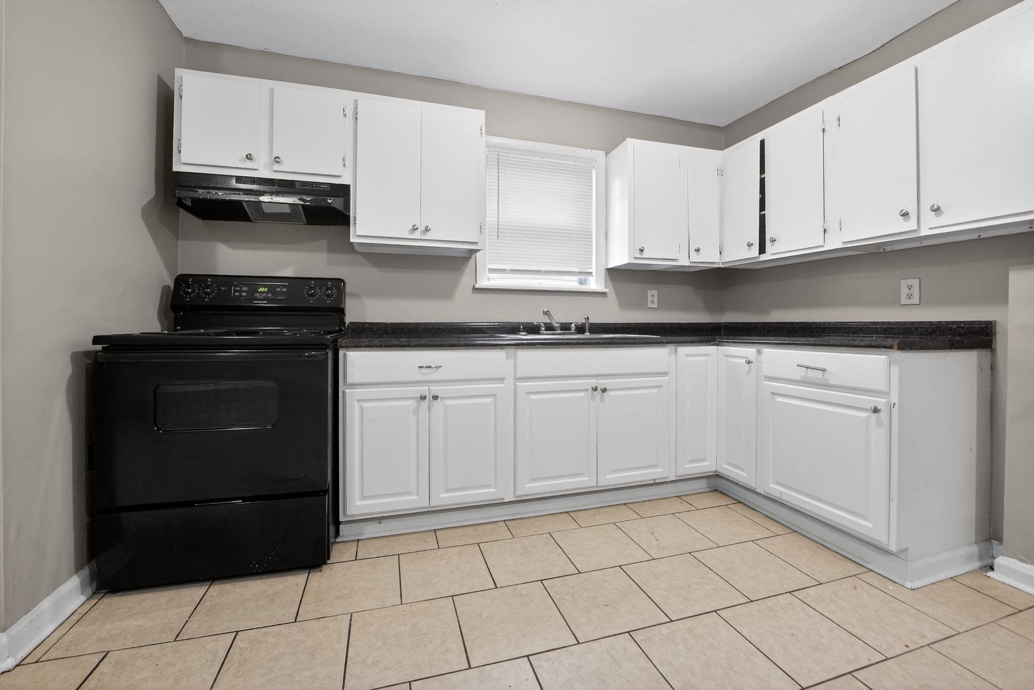 4553 Neely Road Memphis, TN 38109 - Photo 6 of 33 a kitchen with a sink and cabinets