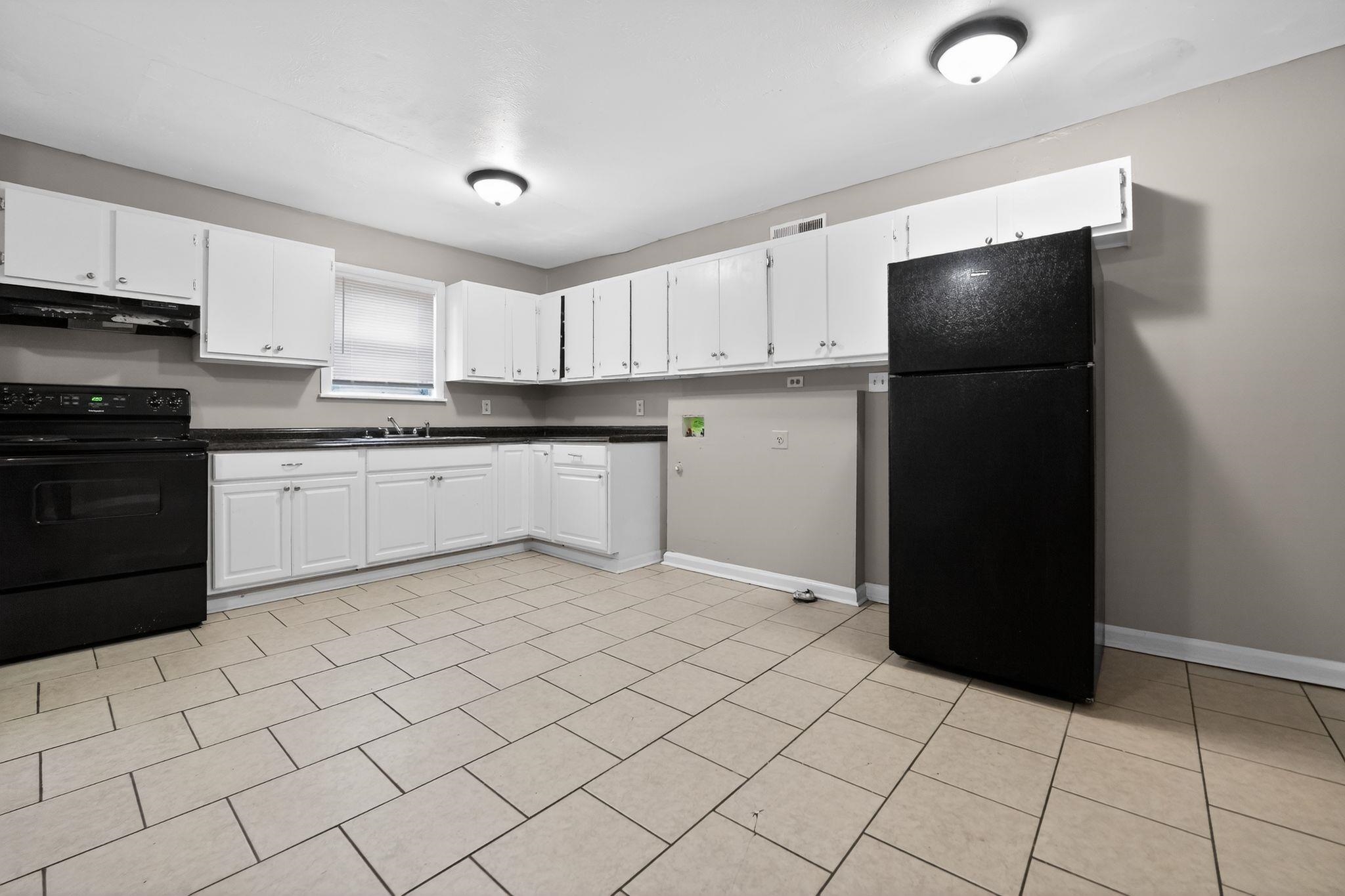 4553 Neely Road Memphis, TN 38109 - Photo 7 of 33 a kitchen with stainless steel appliances granite countertop a refrigerator and a sink
