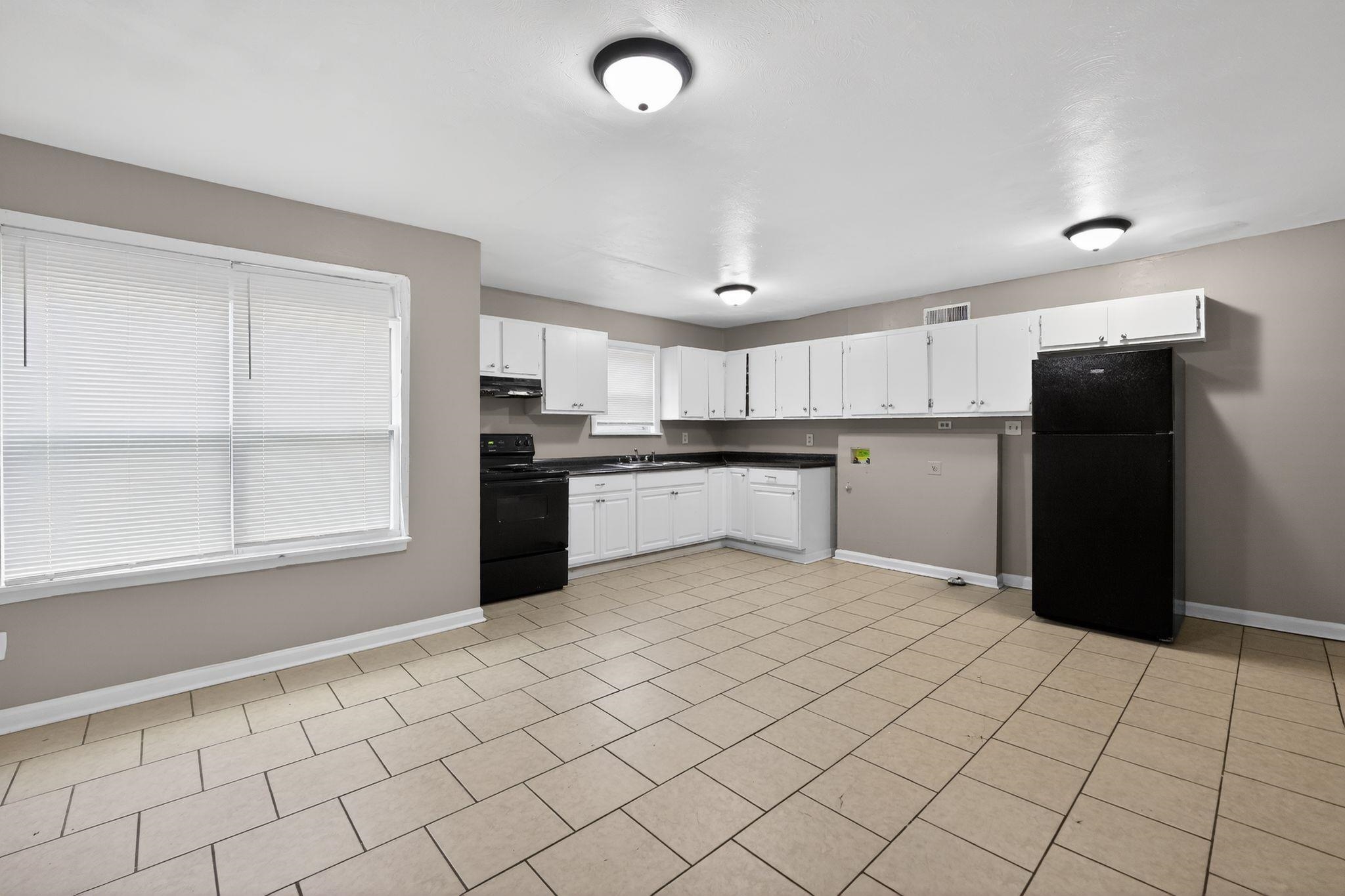 4553 Neely Road Memphis, TN 38109 - Photo 8 of 33 a kitchen with stainless steel appliances granite countertop a refrigerator and a sink