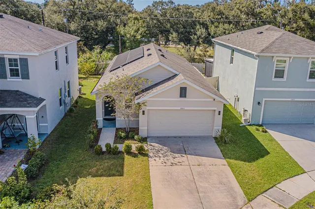 an aerial view of a house with a yard