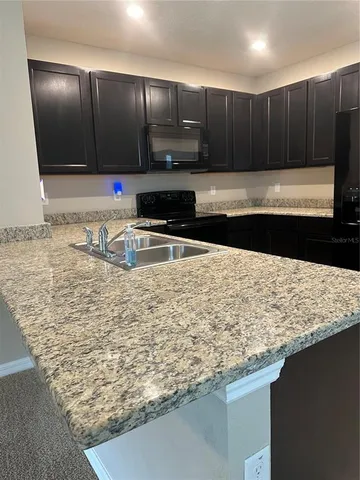 a kitchen with wooden cabinets
