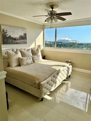 a bedroom with a bed and ceiling fan