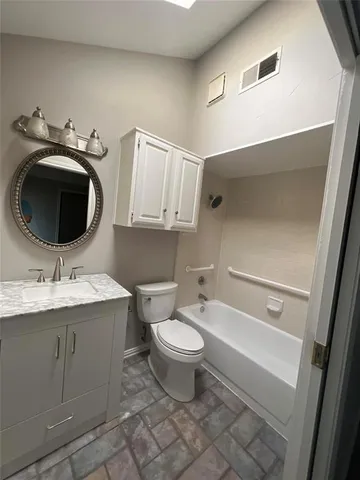 a bathroom with a toilet a sink and a mirror