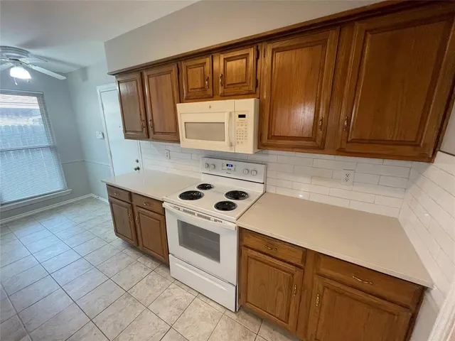 a kitchen with cabinets a sink and a stove top oven