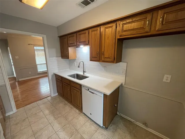 a kitchen with a sink cabinets and window
