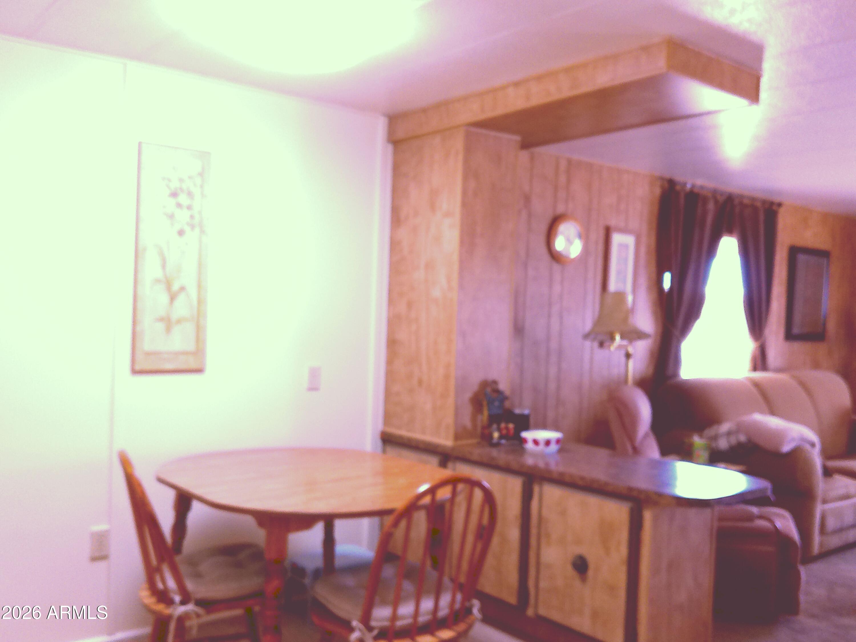 800 West Apache Trail, Unit 142 Apache Junction, AZ 85120 - Photo 12 of 33 a view of a dining room with furniture and wooden floor