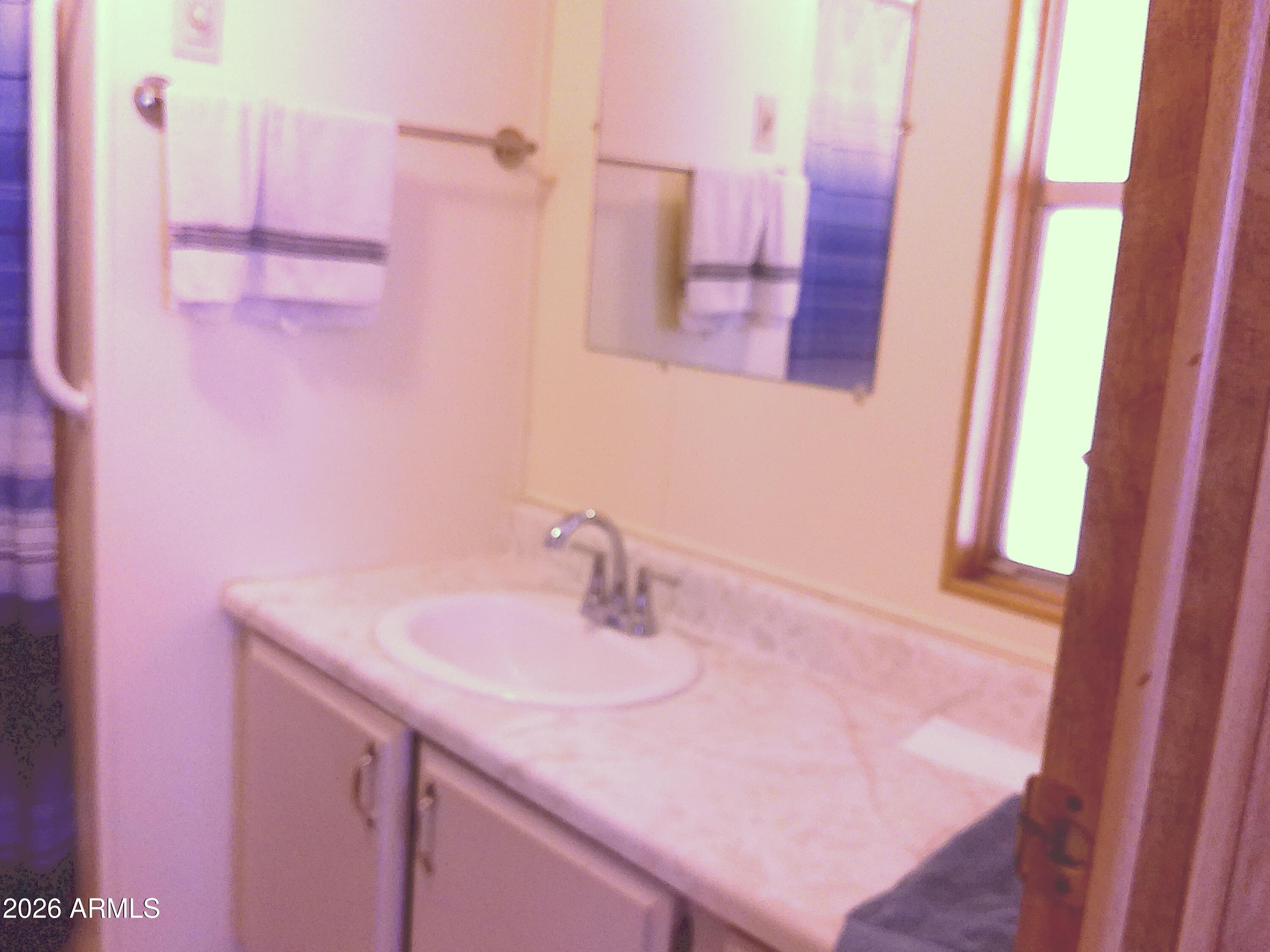 800 West Apache Trail, Unit 142 Apache Junction, AZ 85120 - Photo 18 of 33 a bathroom with a sink and a mirror