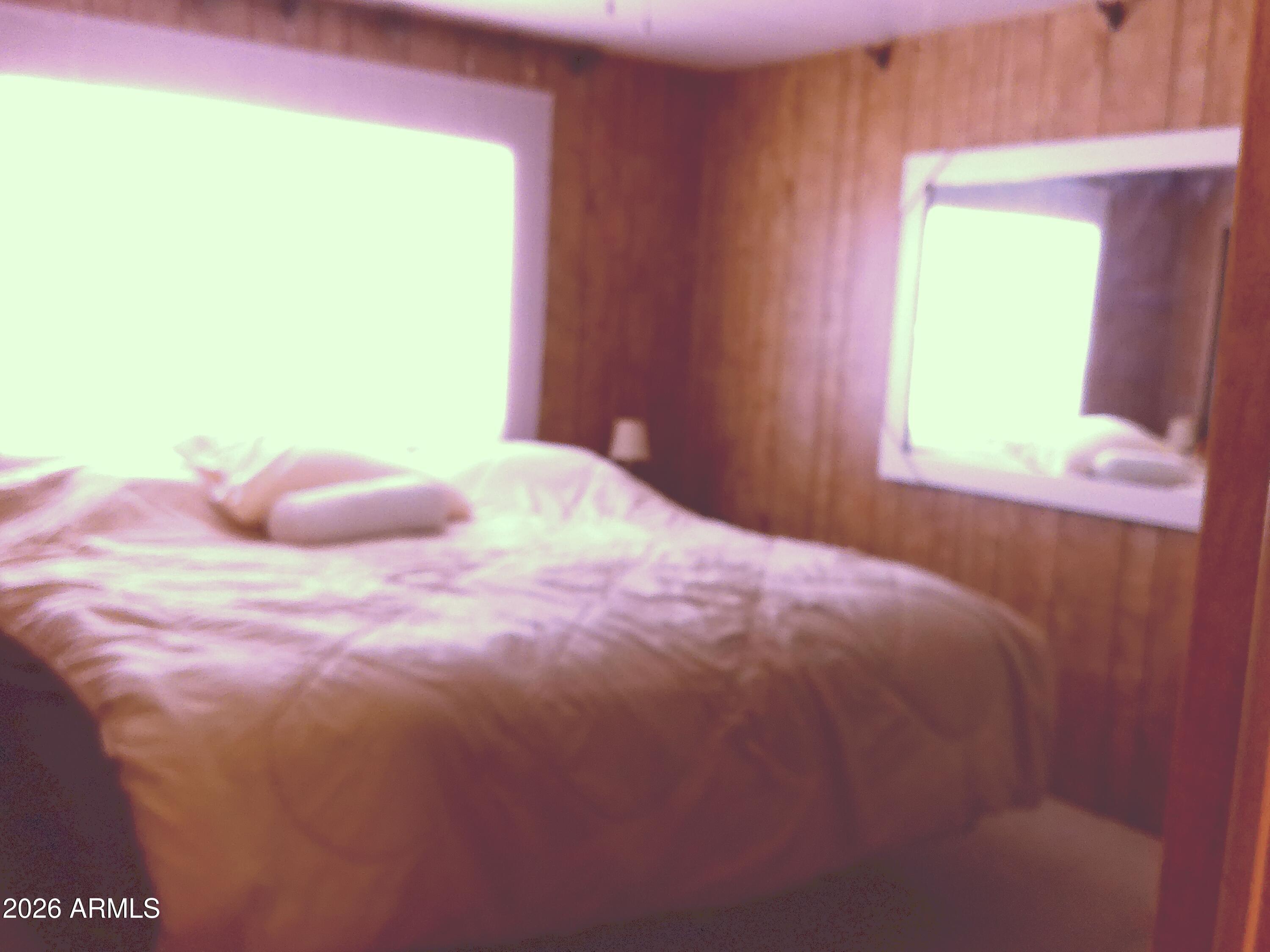 800 West Apache Trail, Unit 142 Apache Junction, AZ 85120 - Photo 21 of 33 a bedroom with a bed and a window