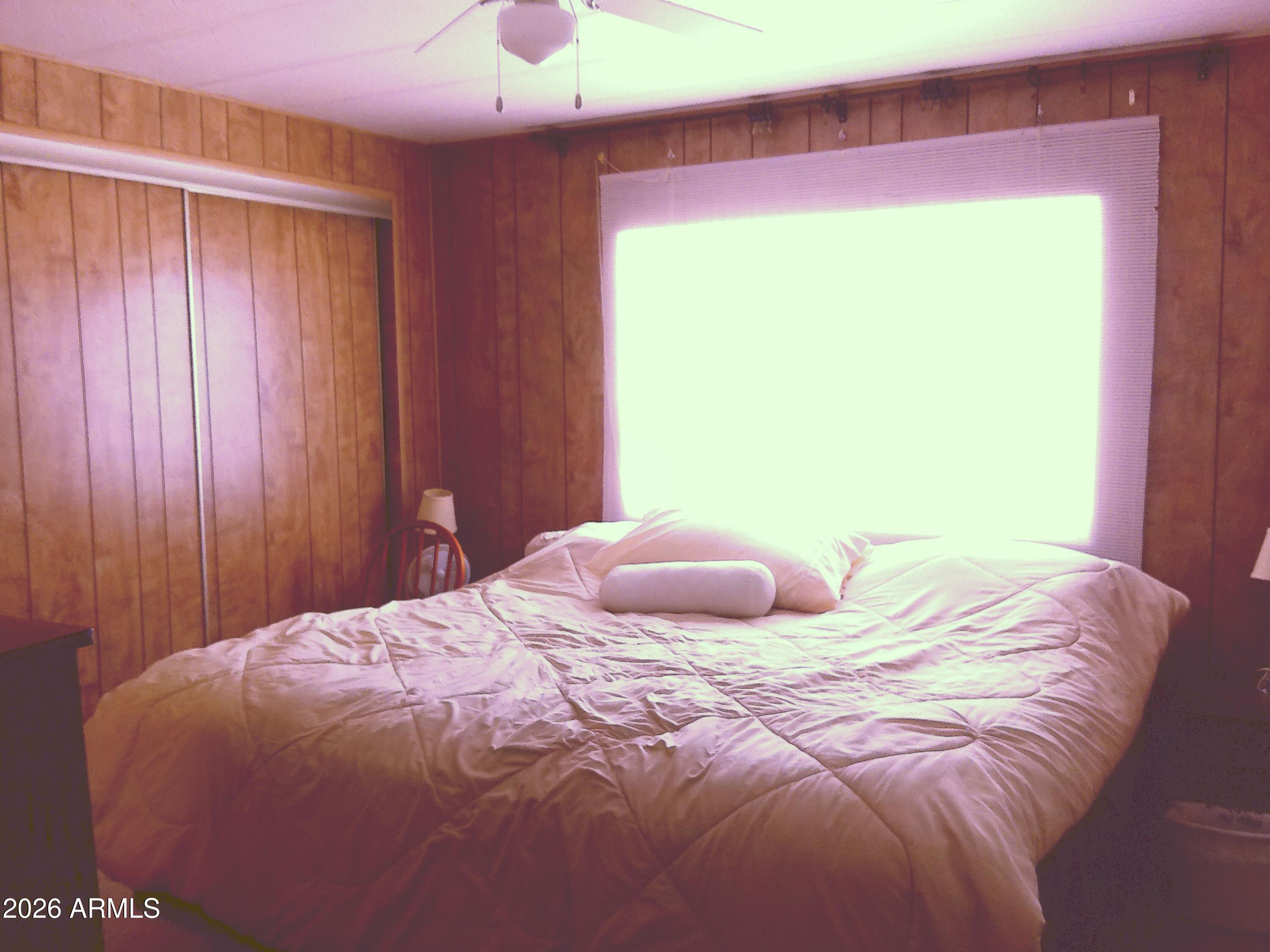 800 West Apache Trail, Unit 142 Apache Junction, AZ 85120 - Photo 22 of 33 a bedroom with a bed and a window
