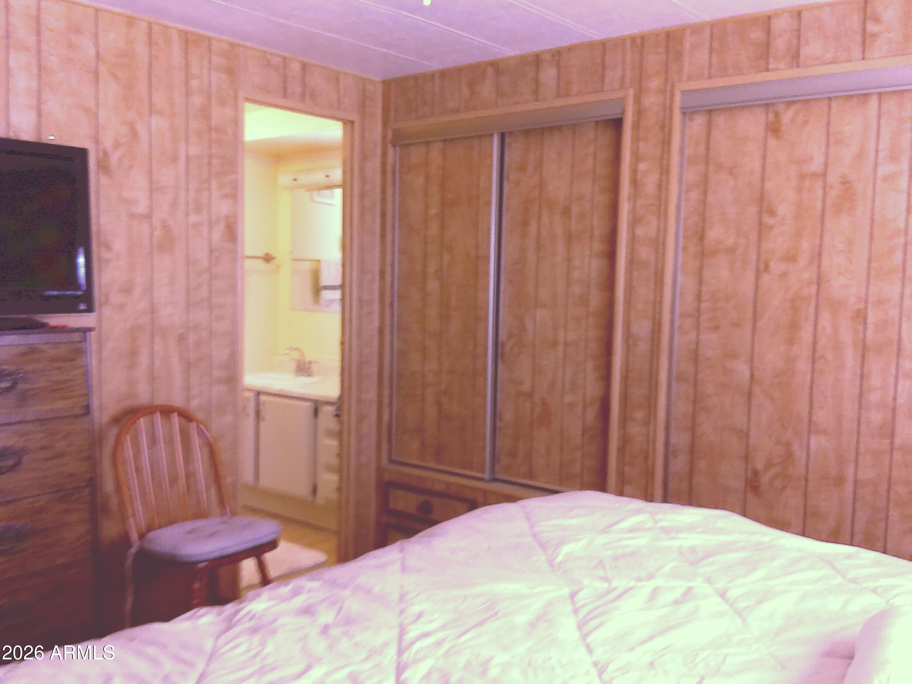 800 West Apache Trail, Unit 142 Apache Junction, AZ 85120 - Photo 23 of 33 a bedroom with a bed and a chair