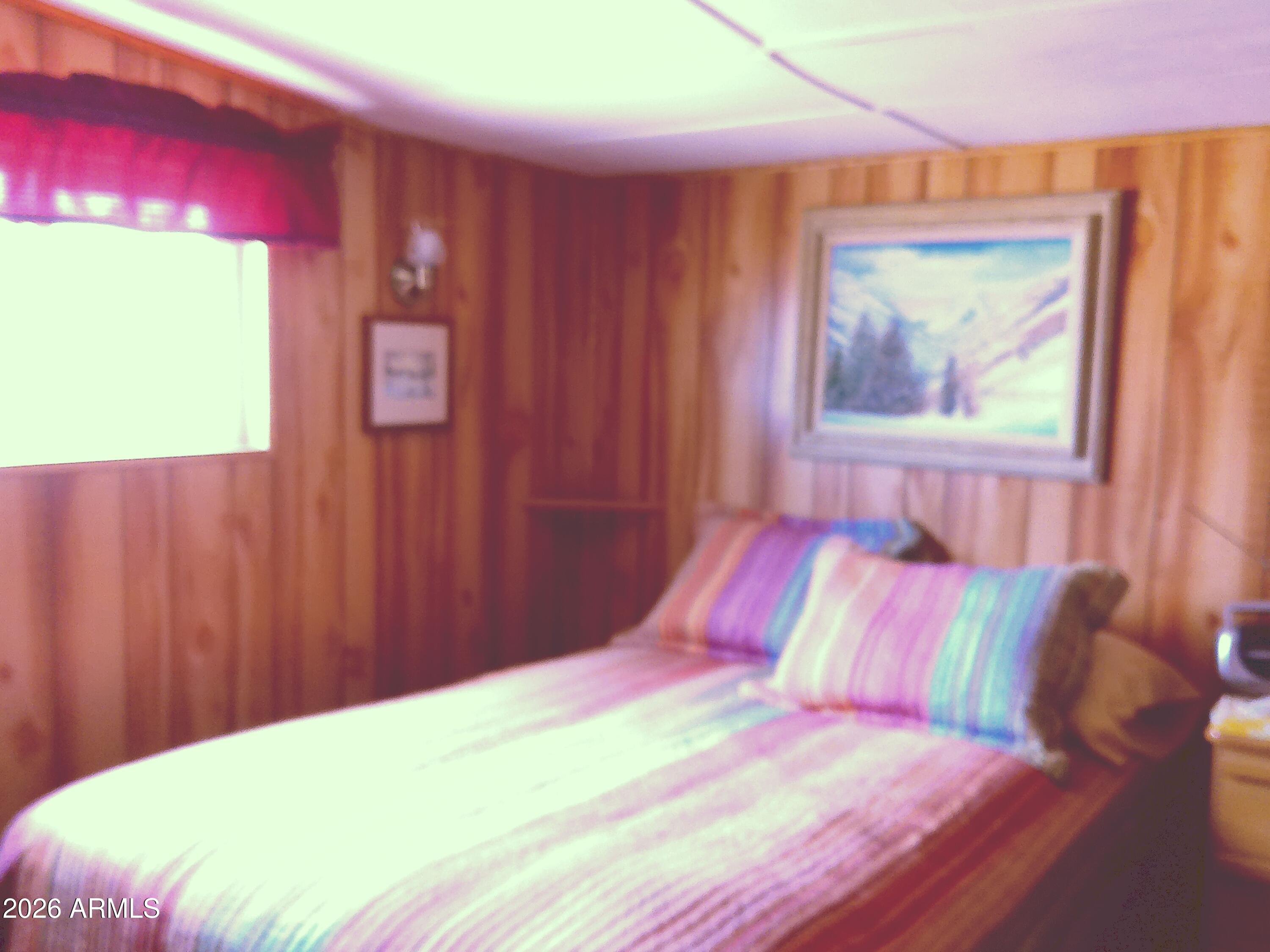 800 West Apache Trail, Unit 142 Apache Junction, AZ 85120 - Photo 29 of 33 a bedroom with a bed and a painting on the wall