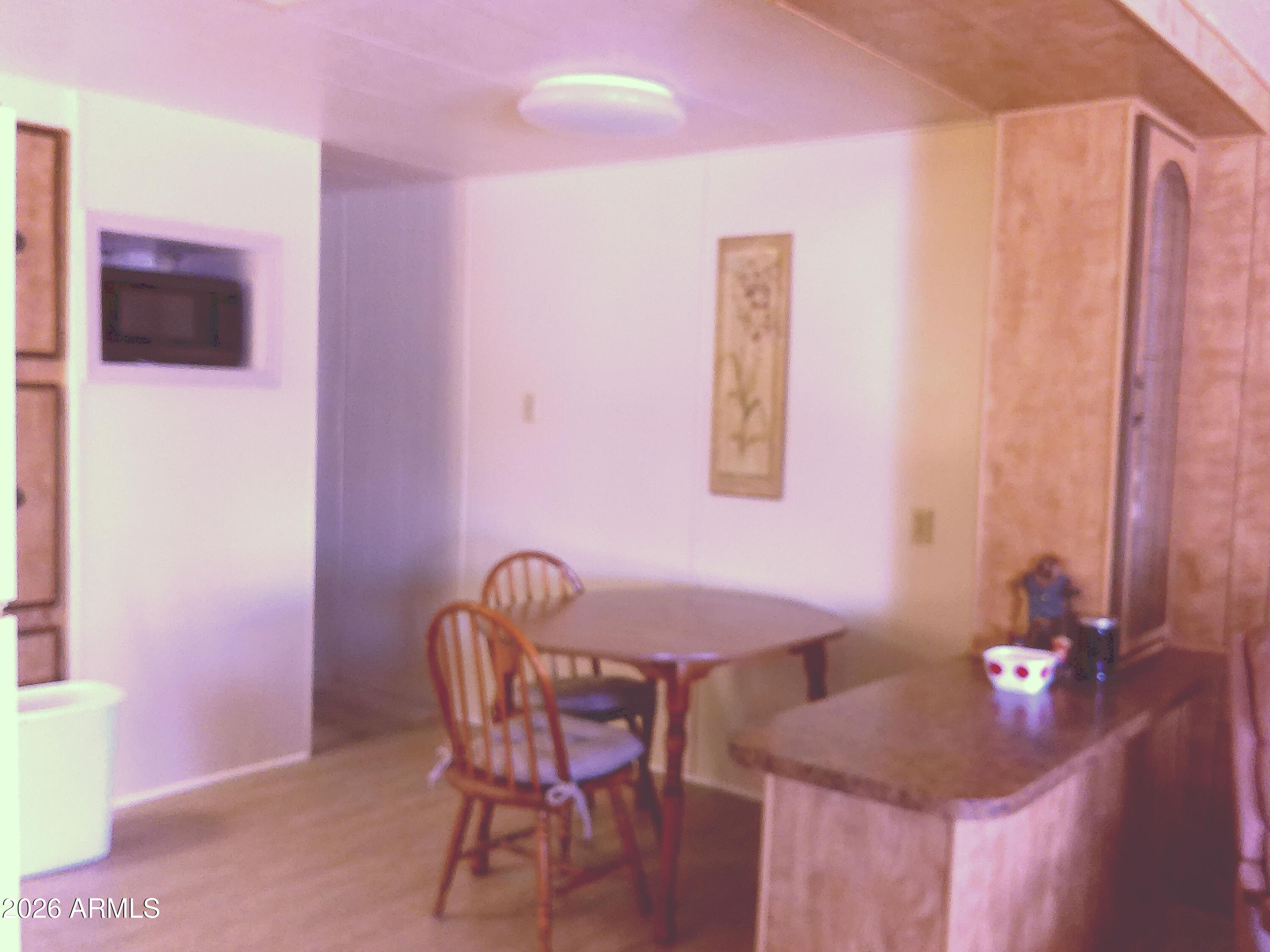 800 West Apache Trail, Unit 142 Apache Junction, AZ 85120 - Photo 7 of 33 a dining room with furniture and wooden floor