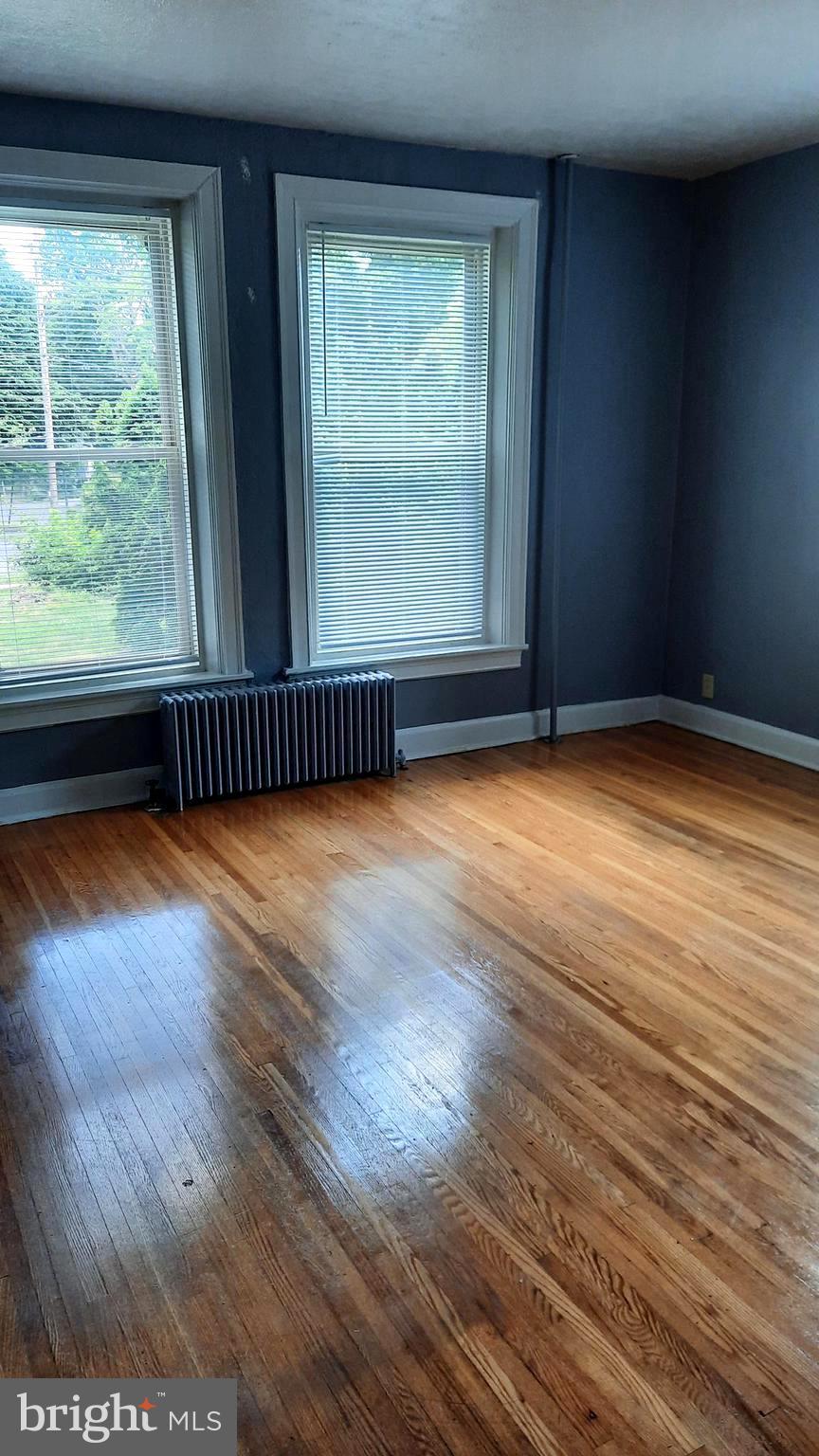 12 South Filbert Street, Unit A9 Mechanicsburg, PA 17055 - Photo 4 of 8 a view of an empty room with wooden floor and a window