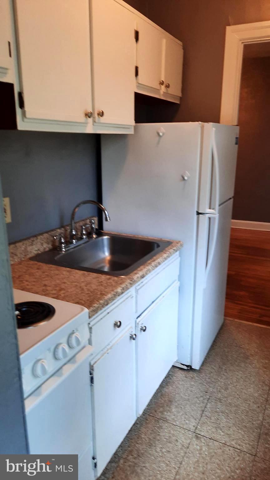 12 South Filbert Street, Unit A9 Mechanicsburg, PA 17055 - Photo 6 of 8 a kitchen with white cabinets and white appliances