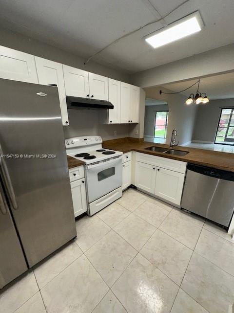 a kitchen with granite countertop a sink a stove and cabinets
