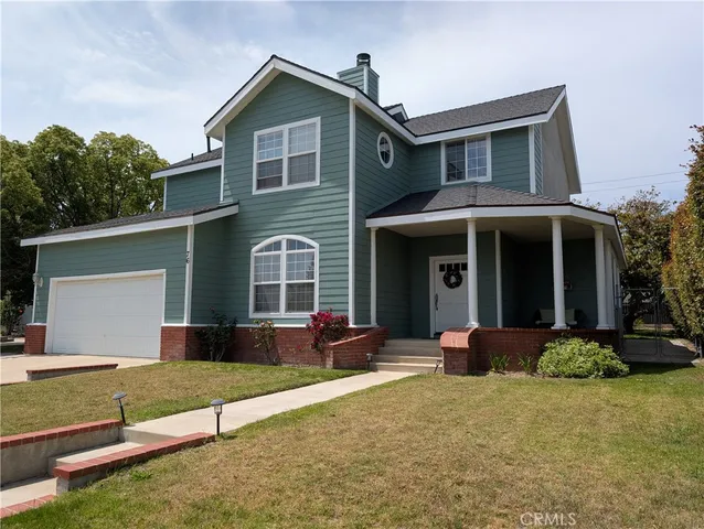a front view of a house with garden