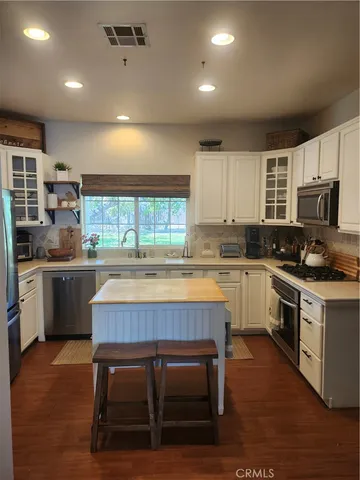 a kitchen with a table chairs sink stove and refrigerator