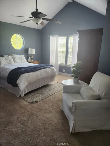 a bedroom with a bed couch and window