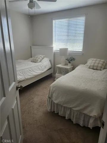 a bedroom with two beds and window