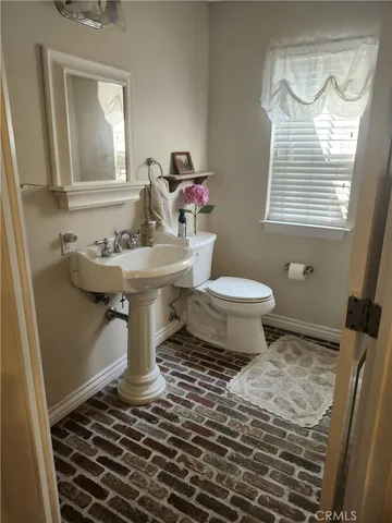 a bathroom with a sink toilet and a mirror