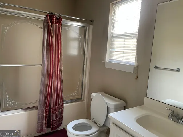 a bathroom with a sink and toilet