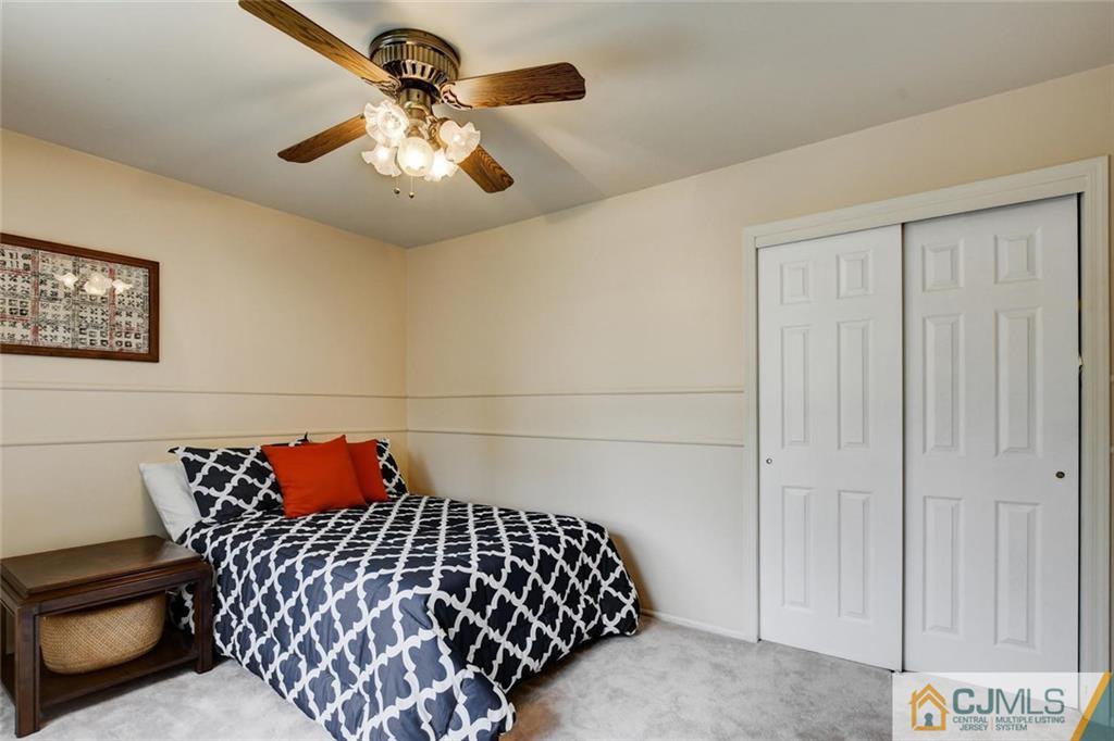 8 Vince Road Somerset, NJ 08873 - Photo 11 of 24 a bedroom with a bed and a chandelier