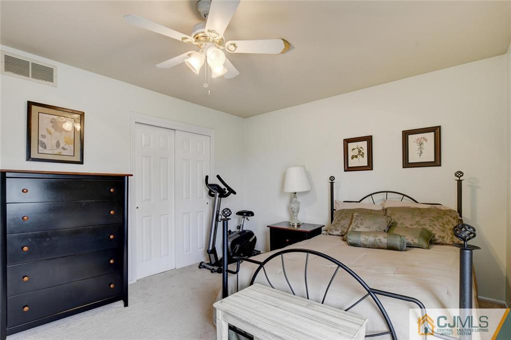 8 Vince Road Somerset, NJ 08873 - Photo 12 of 24 a bedroom with furniture and a gym equipment