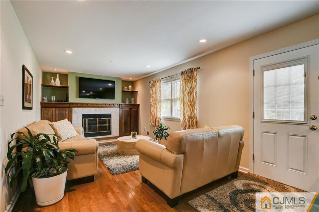 8 Vince Road Somerset, NJ 08873 - Photo 21 of 24 a living room with furniture a fireplace and a flat screen tv