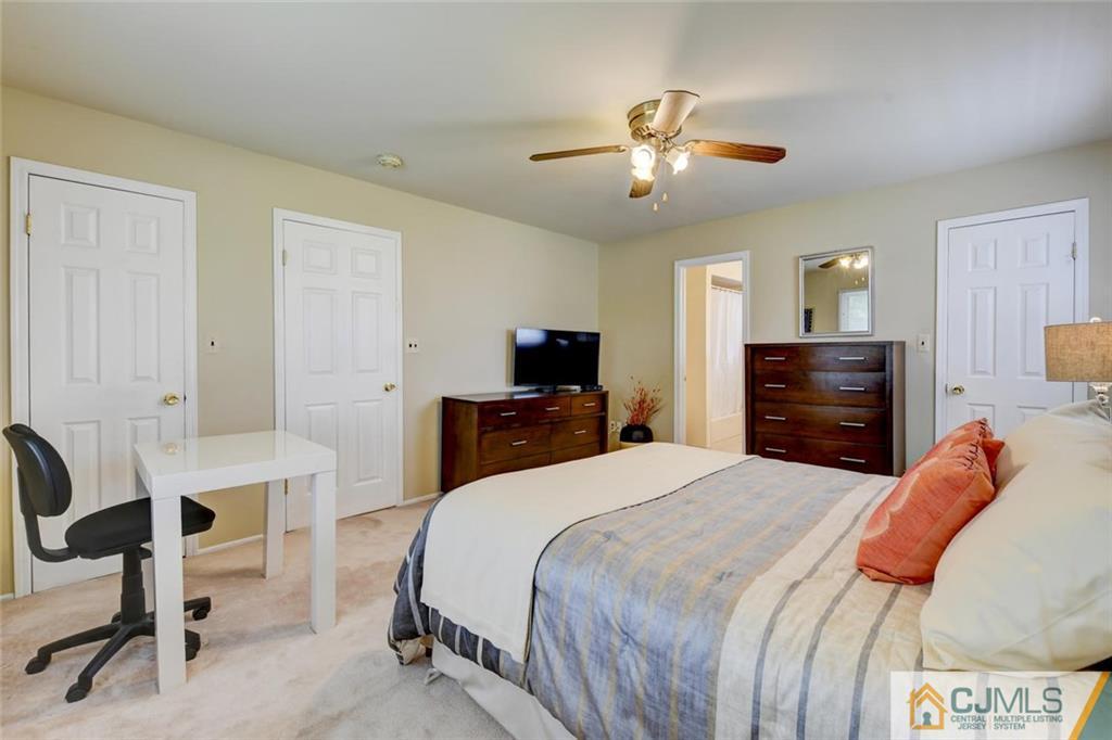 8 Vince Road Somerset, NJ 08873 - Photo 23 of 24 a bedroom with a bed and a chandelier