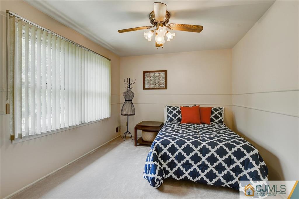 8 Vince Road Somerset, NJ 08873 - Photo 24 of 24 a bedroom with a bed and a chandelier