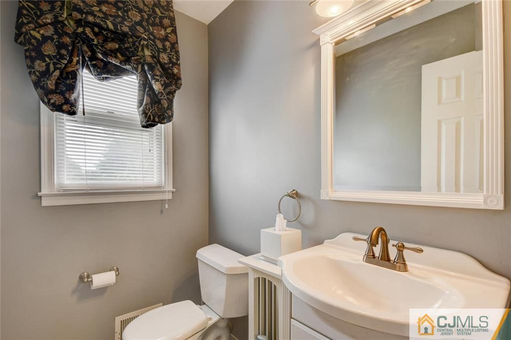 8 Vince Road Somerset, NJ 08873 - Photo 8 of 24 a bathroom with a toilet sink and mirror