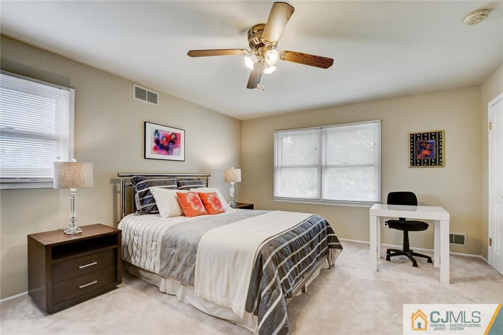 8 Vince Road Somerset, NJ 08873 - Photo 9 of 24 a bedroom with a bed and a desk