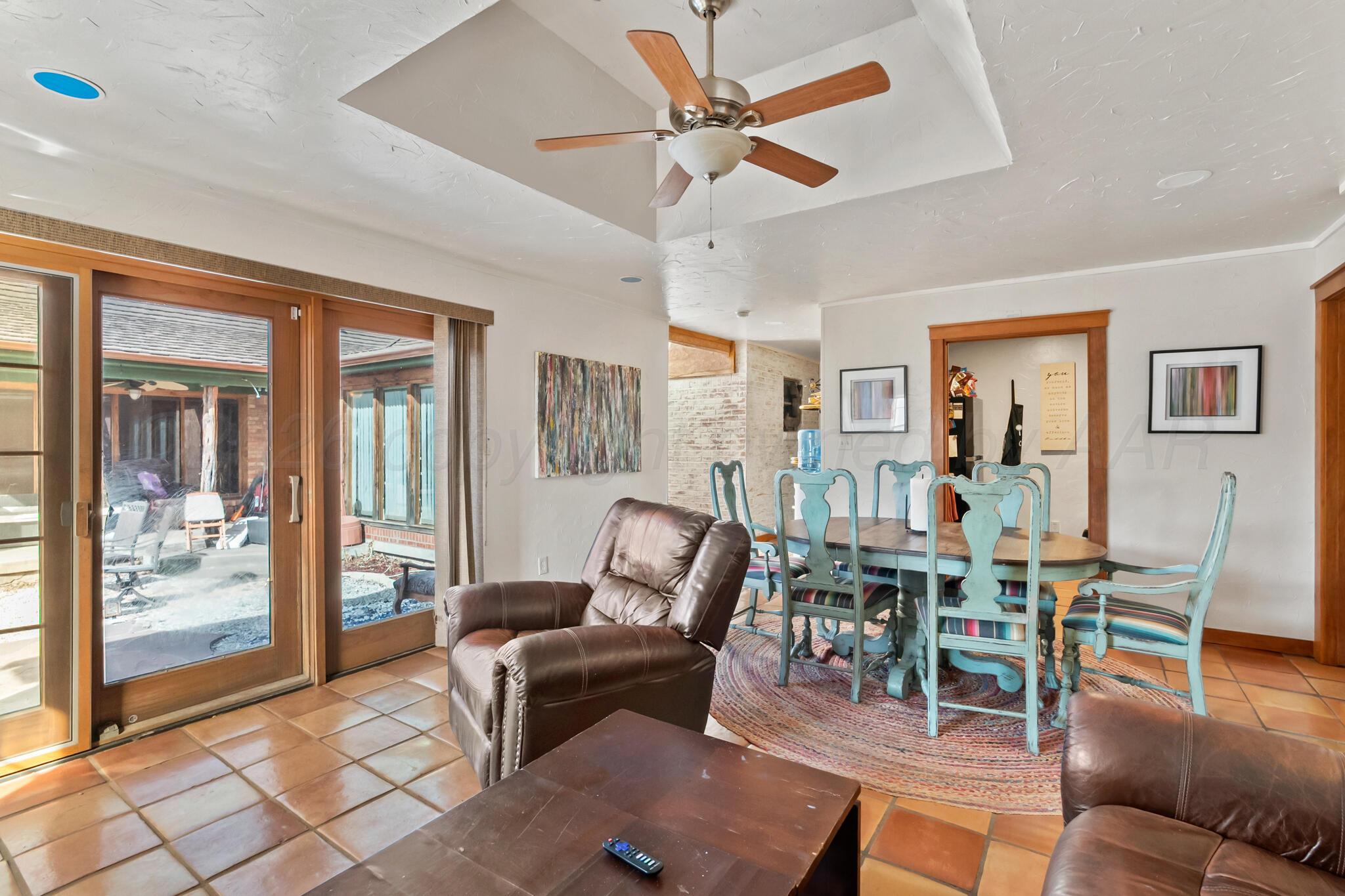 2217 Peach Tree Street Amarillo, TX 79109 - Photo 14 of 26 a living room with furniture a wooden floor and next to a window