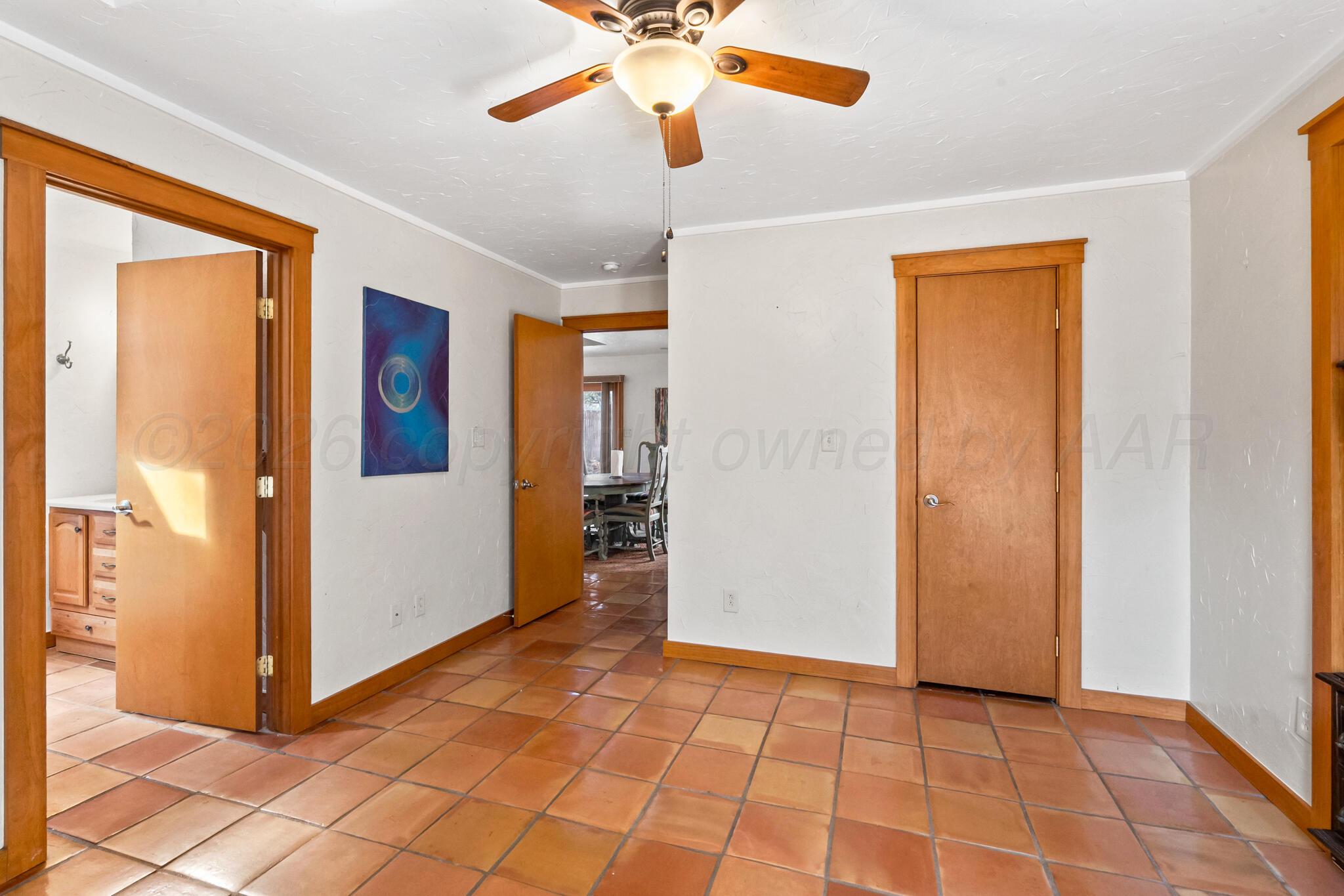 2217 Peach Tree Street Amarillo, TX 79109 - Photo 16 of 26 a view of a room with a chandelier fan and windows