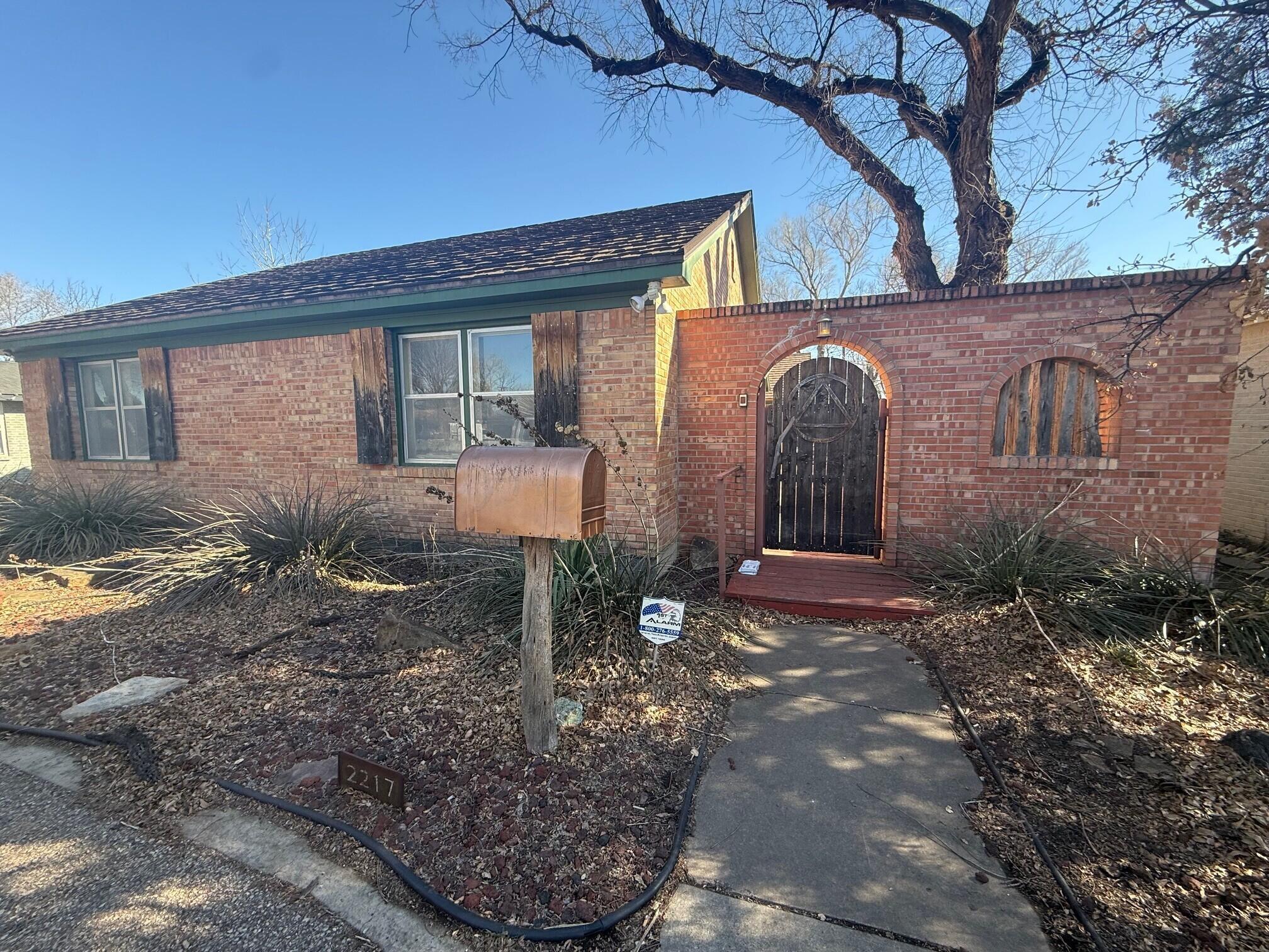 2217 Peach Tree Street Amarillo, TX 79109 - Photo 2 of 26 a front view of a house with garden