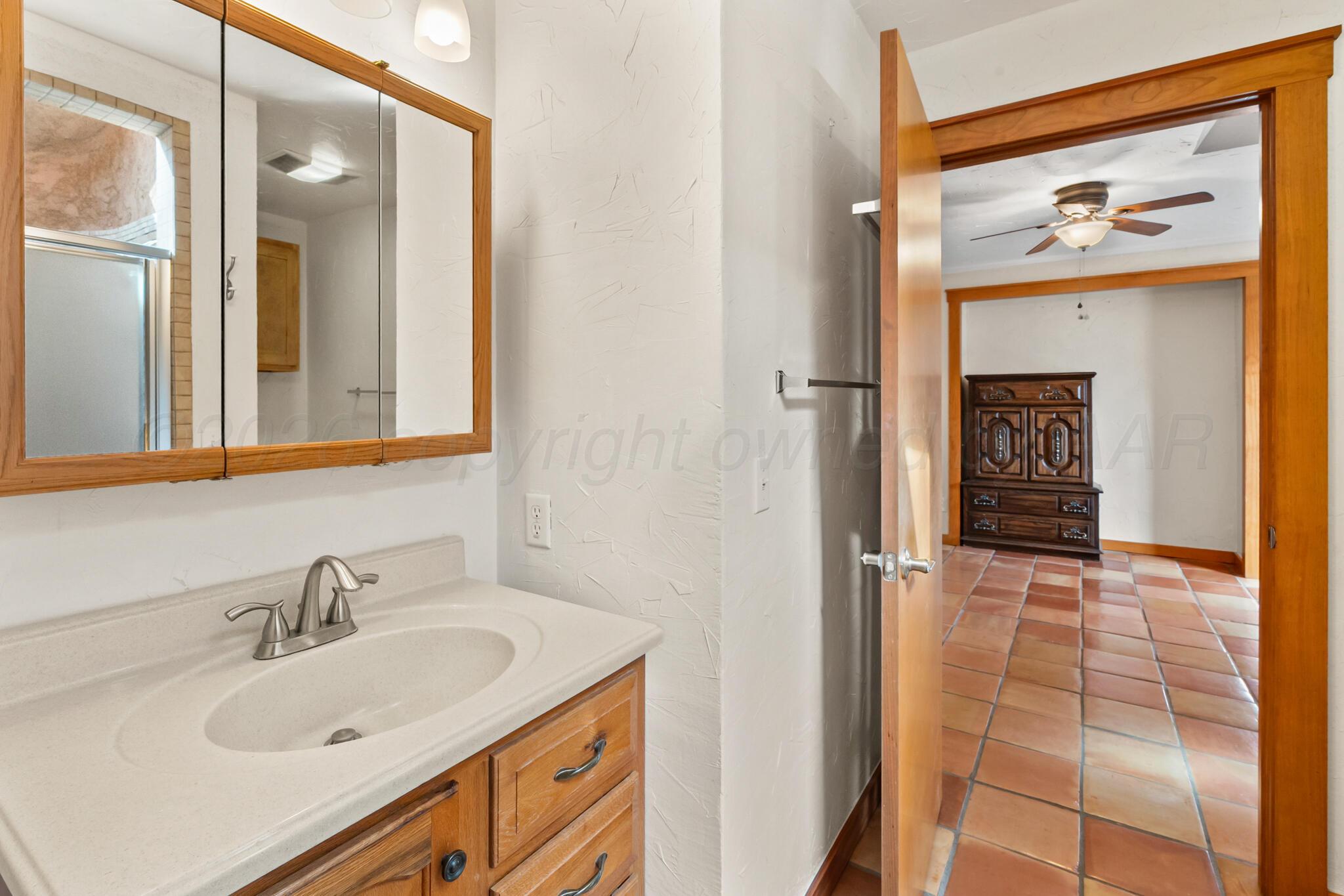 2217 Peach Tree Street Amarillo, TX 79109 - Photo 21 of 26 a bathroom with a sink and a mirror