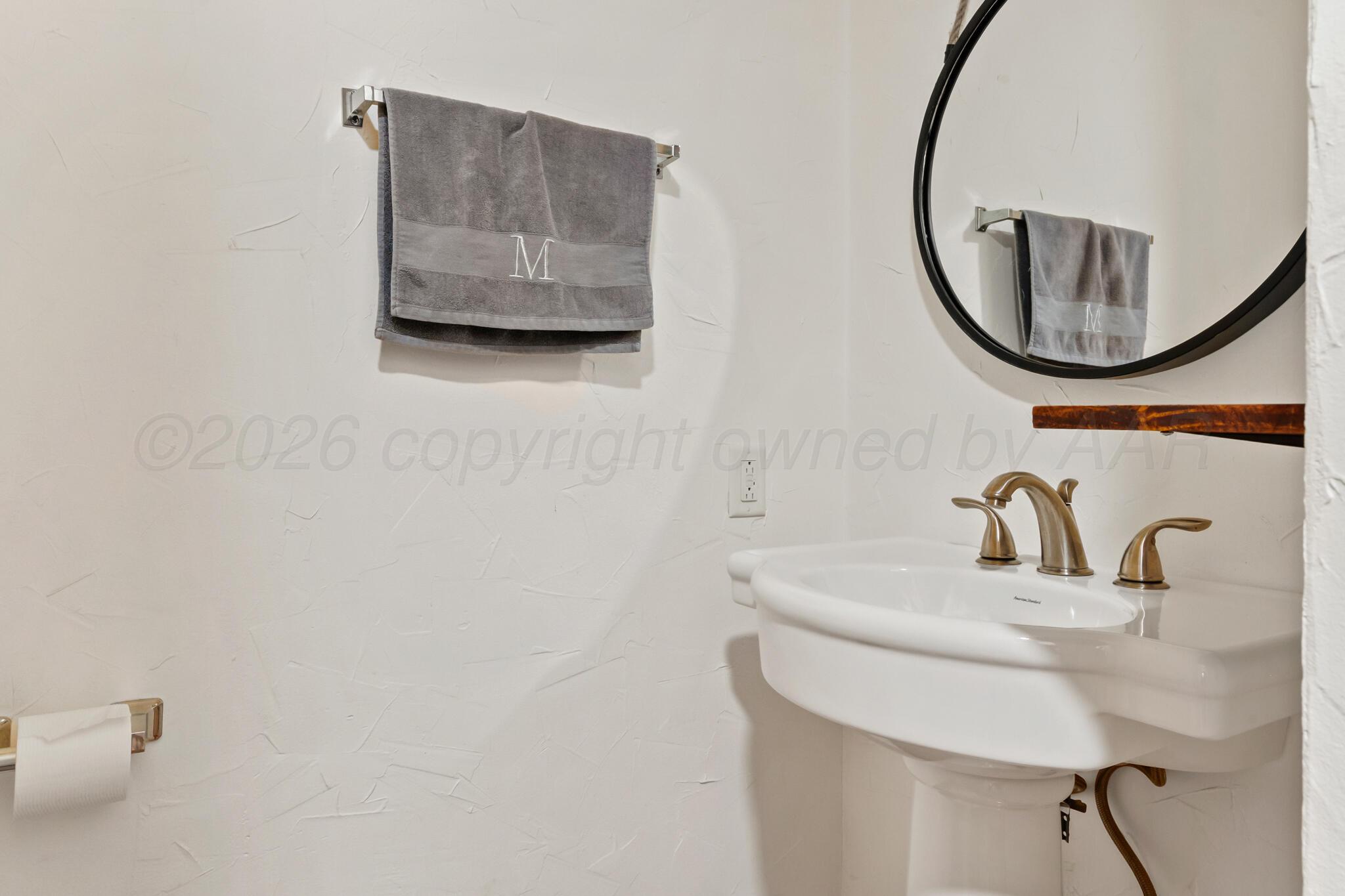 2217 Peach Tree Street Amarillo, TX 79109 - Photo 26 of 26 a bathroom with a sink and a mirror