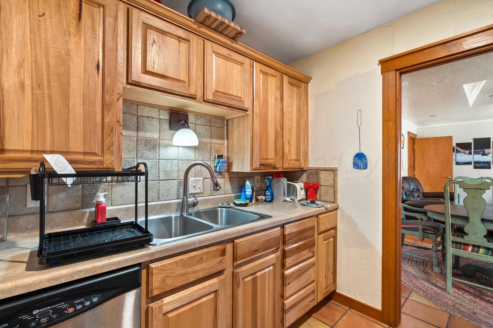 2217 Peach Tree Street Amarillo, TX 79109 - Photo 6 of 26 a kitchen with stainless steel appliances granite countertop a sink and cabinets