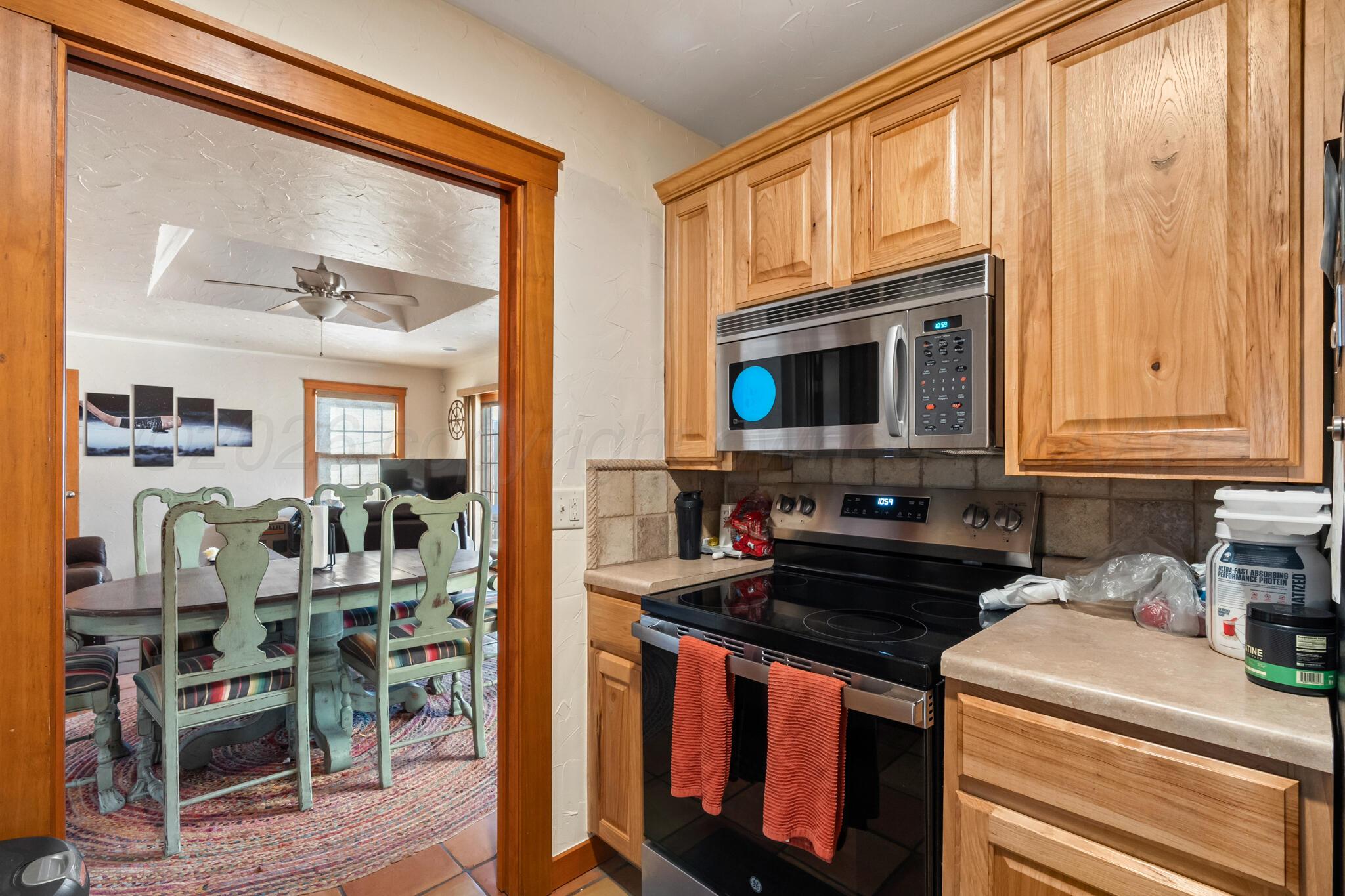 2217 Peach Tree Street Amarillo, TX 79109 - Photo 7 of 26 a kitchen with a stove a sink and a microwave