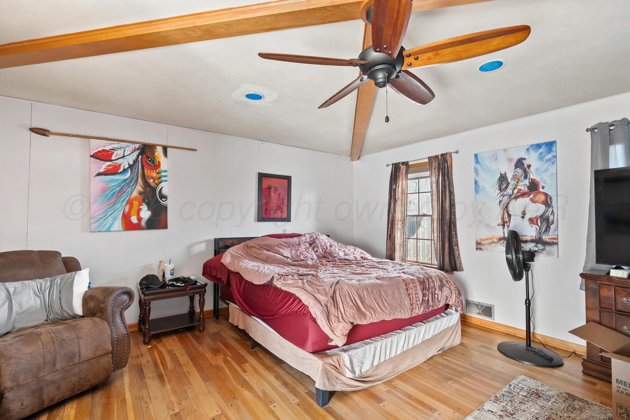 2217 Peach Tree Street Amarillo, TX 79109 - Photo 8 of 26 a bedroom with a bed and a flat screen tv