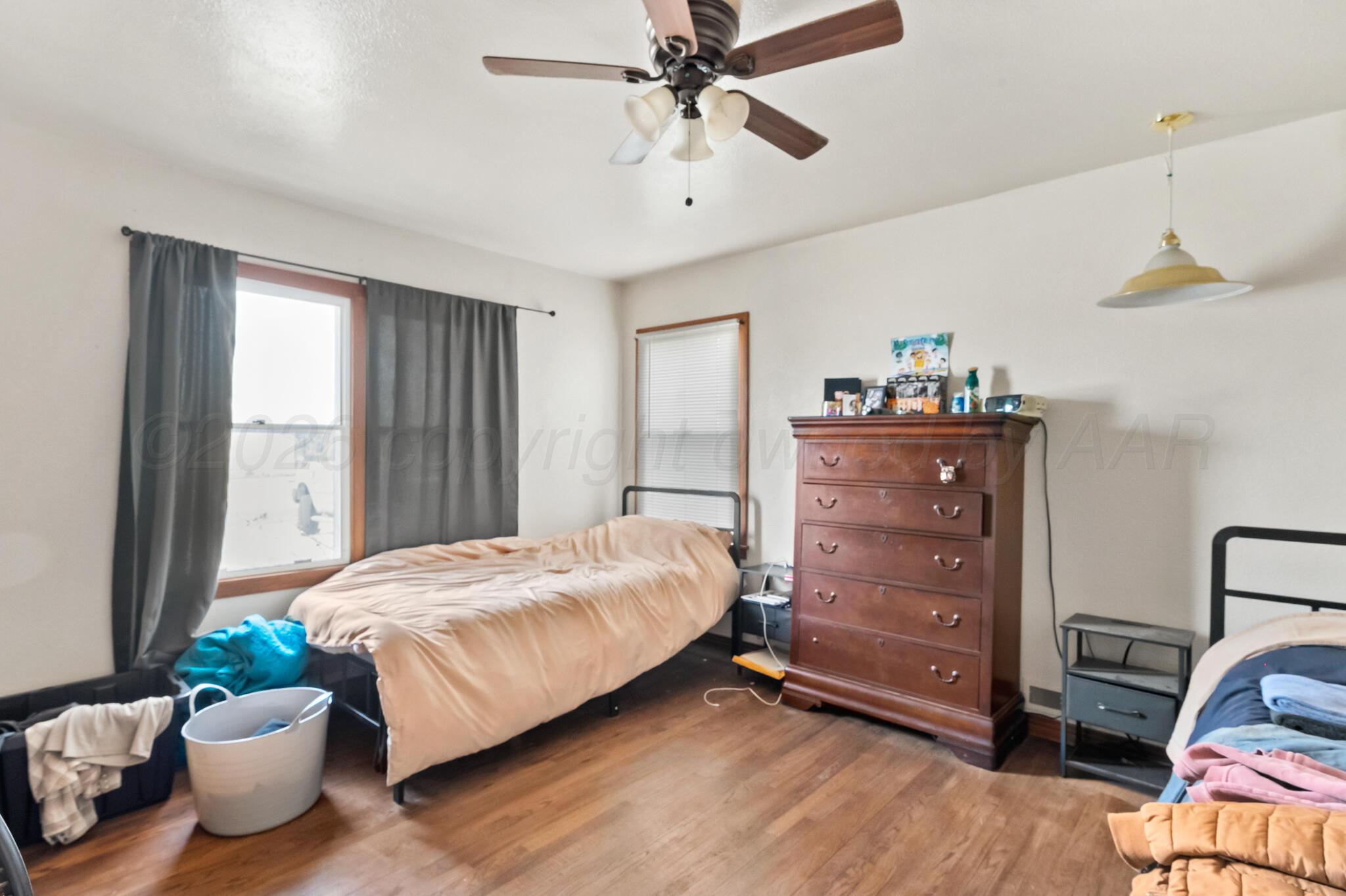 2217 Peach Tree Street Amarillo, TX 79109 - Photo 9 of 26 a bedroom with a bed and window