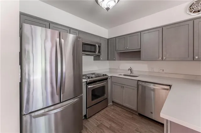 a kitchen with a sink a stove and refrigerator