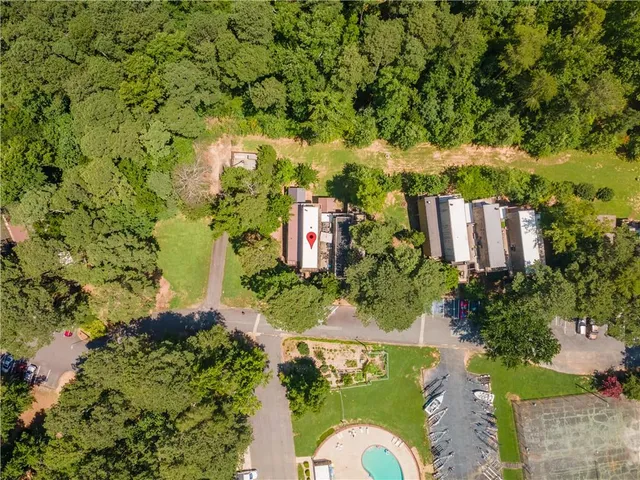 an aerial view of a house with a yard and tennis court