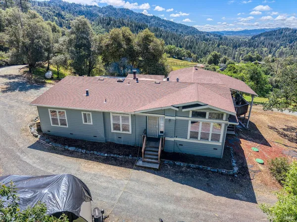 an aerial view of a house with a yard